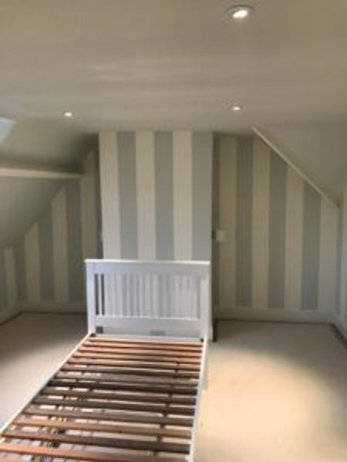 Hand-painted striped bedroom walls, set out by hand